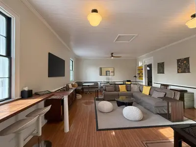 a living room with a couch and a table at Schoolhouse No. 11 * Hudson Valley Upstate Getaway in Stone Ridge