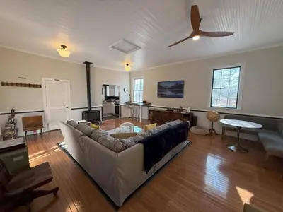 a living room with a couch and a ceiling fan at Schoolhouse No. 11 * Hudson Valley Upstate Getaway in Stone Ridge