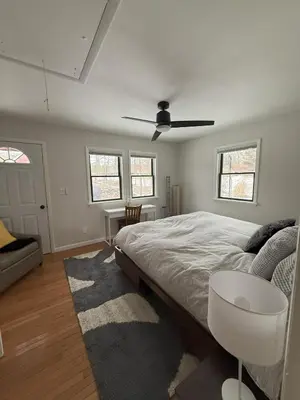 a bedroom with a bed and a table and a couch at Schoolhouse No. 11 * Hudson Valley Upstate Getaway in Stone Ridge