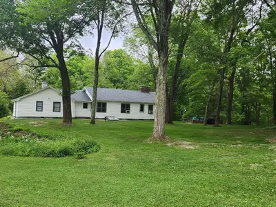 a white house with trees in the yard at Near Marist/Vassar/Culinary Inst./Historic Sites! in Pleasant Valley