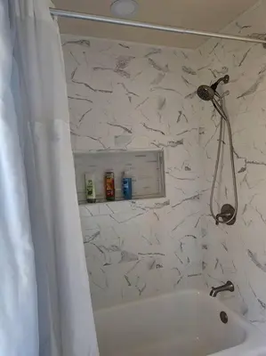 a bathroom with a white tub and a shower at Near Marist/Vassar/Culinary Inst./Historic Sites! in Pleasant Valley