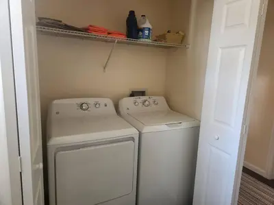 a small laundry room with a washer and dryer at Near Marist/Vassar/Culinary Inst./Historic Sites! in Pleasant Valley