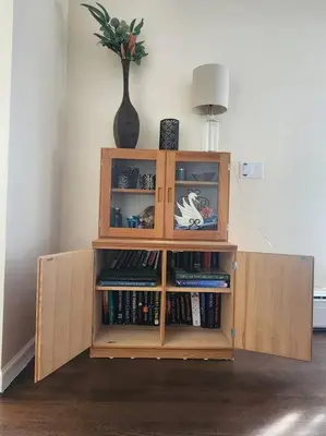 a wooden book shelf with books in it at Near Marist/Vassar/Culinary Inst./Historic Sites! in Pleasant Valley