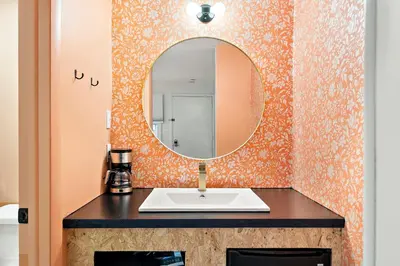 a bathroom with a sink and a mirror at The Brooks Motel in Hillsdale