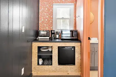 a kitchen with a counter with microwaves and a microwave at The Brooks Motel in Hillsdale
