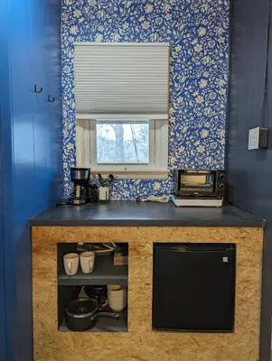 a kitchen with a counter with a sink and a mirror at The Brooks Motel in Hillsdale