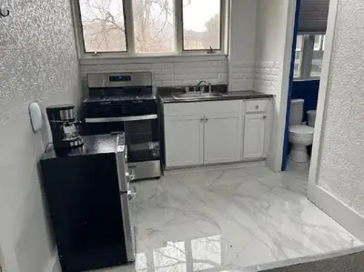 a kitchen with a stove and a sink at The Brooks Motel in Hillsdale