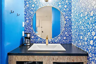 a bathroom with a sink and a mirror at The Brooks Motel in Hillsdale