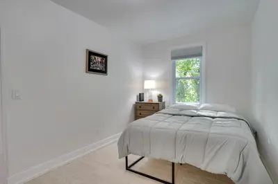 a white bedroom with a bed and a window at Modern Hastings-On-Hudson Home Near River! in Hastings-on-Hudson