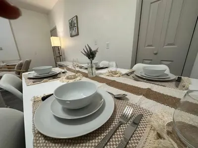 a dining room table with plates and silverware on it at GREAT VALUE Luxe Style Queen Beds WD Parking in Schenectady