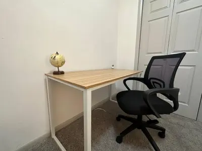 a desk with a chair and a vase on it at GREAT VALUE Luxe Style Queen Beds WD Parking in Schenectady