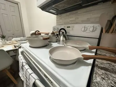 a kitchen with a stove with pots and pans on it at GREAT VALUE Luxe Style Queen Beds WD Parking in Schenectady