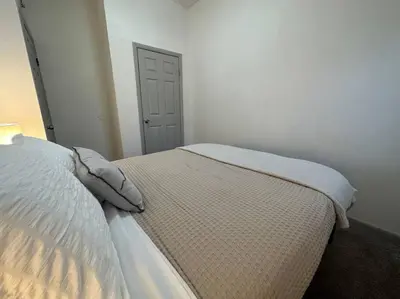 a bed with two pillows on it in a bedroom at GREAT VALUE Luxe Style Queen Beds WD Parking in Schenectady