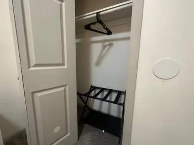 a closet with a white door and a black rack at GREAT VALUE Luxe Style Queen Beds WD Parking in Schenectady