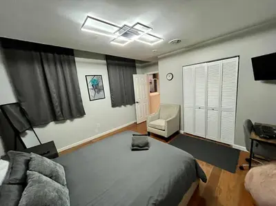 a bedroom with a bed and a couch and a chair at Downtown Albany 1 Bed + Workstation @ Maiden Lane in Albany