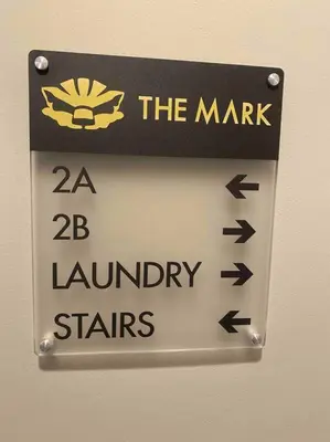 a sign on a wall that reads the market and laundry stars at Downtown Albany 1 Bed + Workstation @ Maiden Lane in Albany