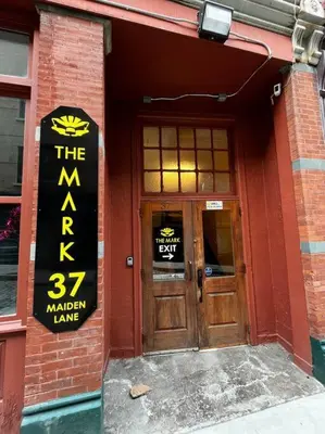 a red brick building with a sign on the door at Downtown Albany 1 Bed + Workstation @ Maiden Lane in Albany
