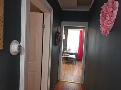 a hallway with a door leading to a room with a window at Fashionably cozy2 in Meriden