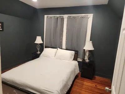 a bedroom with a white bed and two lamps at Fashionably cozy2 in Meriden