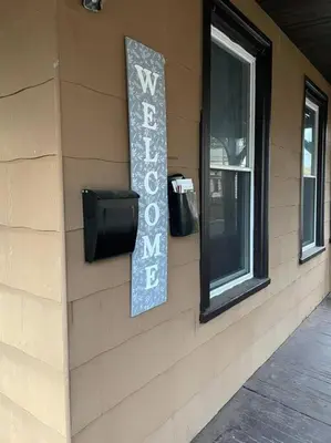 a sign on the side of a building with a window at Fashionably cozy2 in Meriden