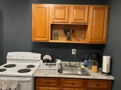 a kitchen with a white stove and a sink at Fashionably cozy2 in Meriden