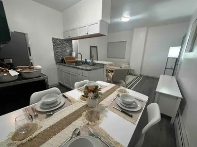 a kitchen and living room with a table and chairs at 2 KING Beds WD Parking Stylish GREAT VALUE in Schenectady