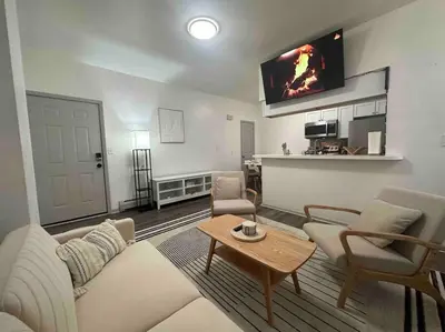 a living room with a couch and a table at 2 KING Beds WD Parking Stylish GREAT VALUE in Schenectady