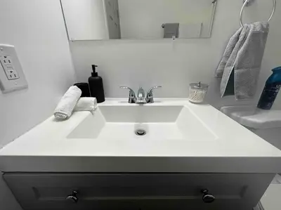 a bathroom with a white sink and a mirror at 2 KING Beds WD Parking Stylish GREAT VALUE in Schenectady