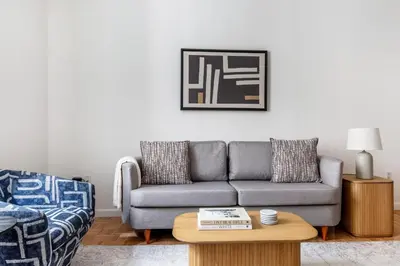 a living room with a couch and a table at Fidi 1br w doorman wd nr south st seaport NYC-1306 in New York