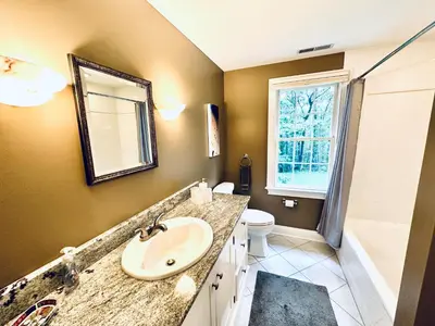 a bathroom with a sink and a toilet and a mirror at Upmarket Country Retreat, Washington, Connecticut in Washington