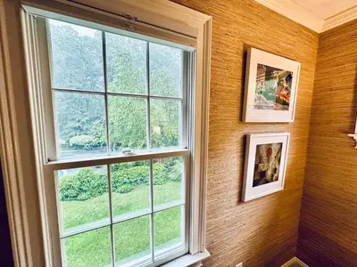 a window in a wall with a view of a field at Upmarket Country Retreat, Washington, Connecticut in Washington