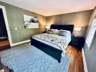 a bedroom with a bed and a blue rug at Upmarket Country Retreat, Washington, Connecticut in Washington