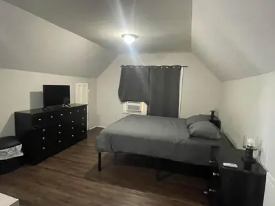 a bedroom with a bed and a dresser and a television at Private Apt In Middletown-wesleyan in Middletown