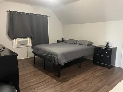 a bedroom with a bed and a black dresser at Private Apt In Middletown-wesleyan in Middletown