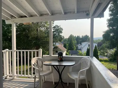 a table and chairs on a porch with a view at Private Apt In Middletown-wesleyan in Middletown