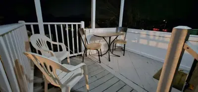 a porch with chairs and a table on a deck at Private Apt In Middletown-wesleyan in Middletown