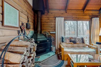 a living room with a fireplace in a log cabin at Log Ski Lodge in Wilmington