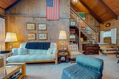 a living room with a couch and an american flag at Log Ski Lodge in Wilmington