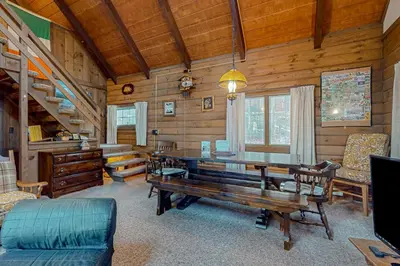 a dining room with a table and chairs in a cabin at Log Ski Lodge in Wilmington
