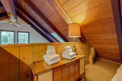 a room with towels on a table in a house at Log Ski Lodge in Wilmington