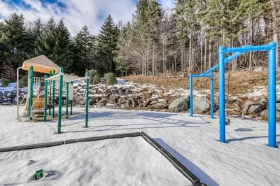 an empty playground in the snow at Log Ski Lodge in Wilmington