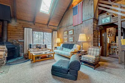 a living room with a couch and a fireplace at Log Ski Lodge in Wilmington