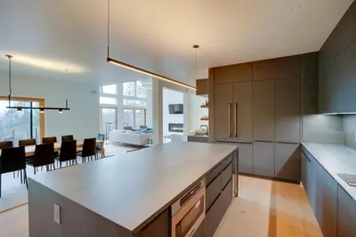 a kitchen with a counter and a dining room at Brand New Luxury Ski Cabin - 2 Mi to Windham Mtn! in Windham