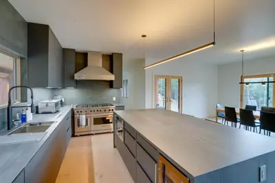 a large kitchen with a counter top and a sink at Brand New Luxury Ski Cabin - 2 Mi to Windham Mtn! in Windham