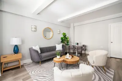 a living room with a couch and a table at 73-201 New 1BR 1Bth UWS Doorman Gym in New York