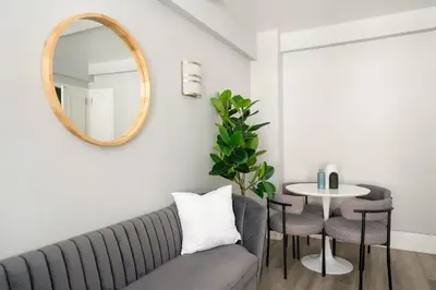 a living room with a couch and a mirror at 73-201 New 1BR 1Bth UWS Doorman Gym in New York