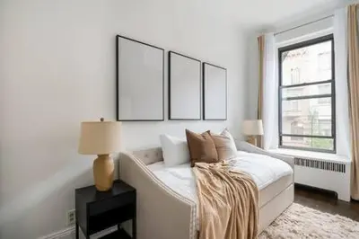 a white bedroom with a white couch and a window at 91-2A Stylish 3BR 2Bth with W D in New York