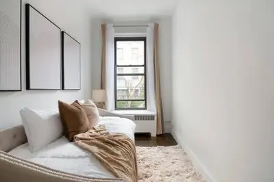a living room with a white couch and a window at 91-2A Stylish 3BR 2Bth with W D in New York