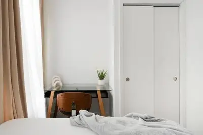 a bedroom with a bed and a desk and a window at 91-2A Stylish 3BR 2Bth with W D in New York