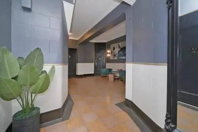 a lobby with a plant in the middle of a room at 91-2A Stylish 3BR 2Bth with W D in New York